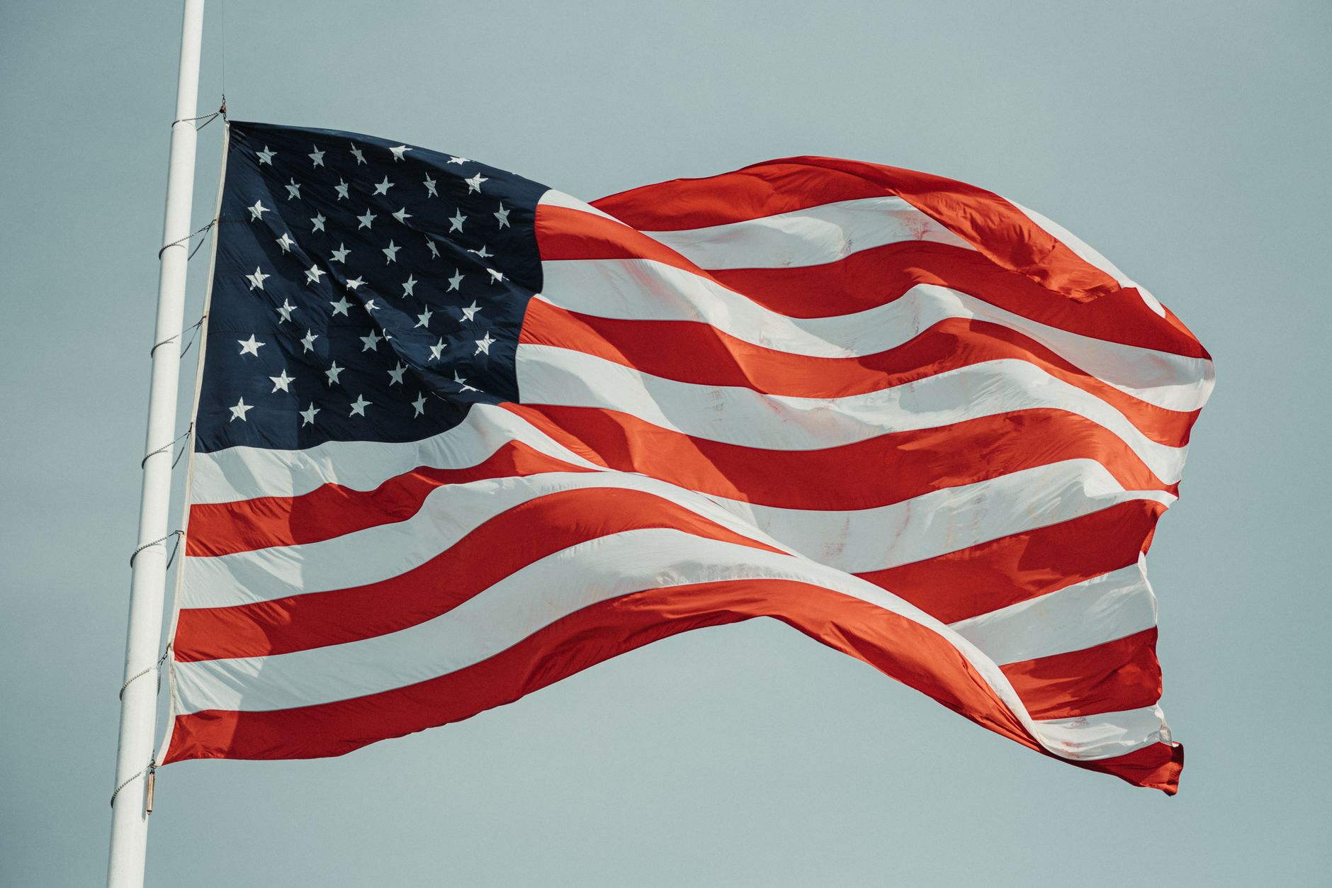 A close-up of the American flag waving against the sky, symbolizing patriotism.