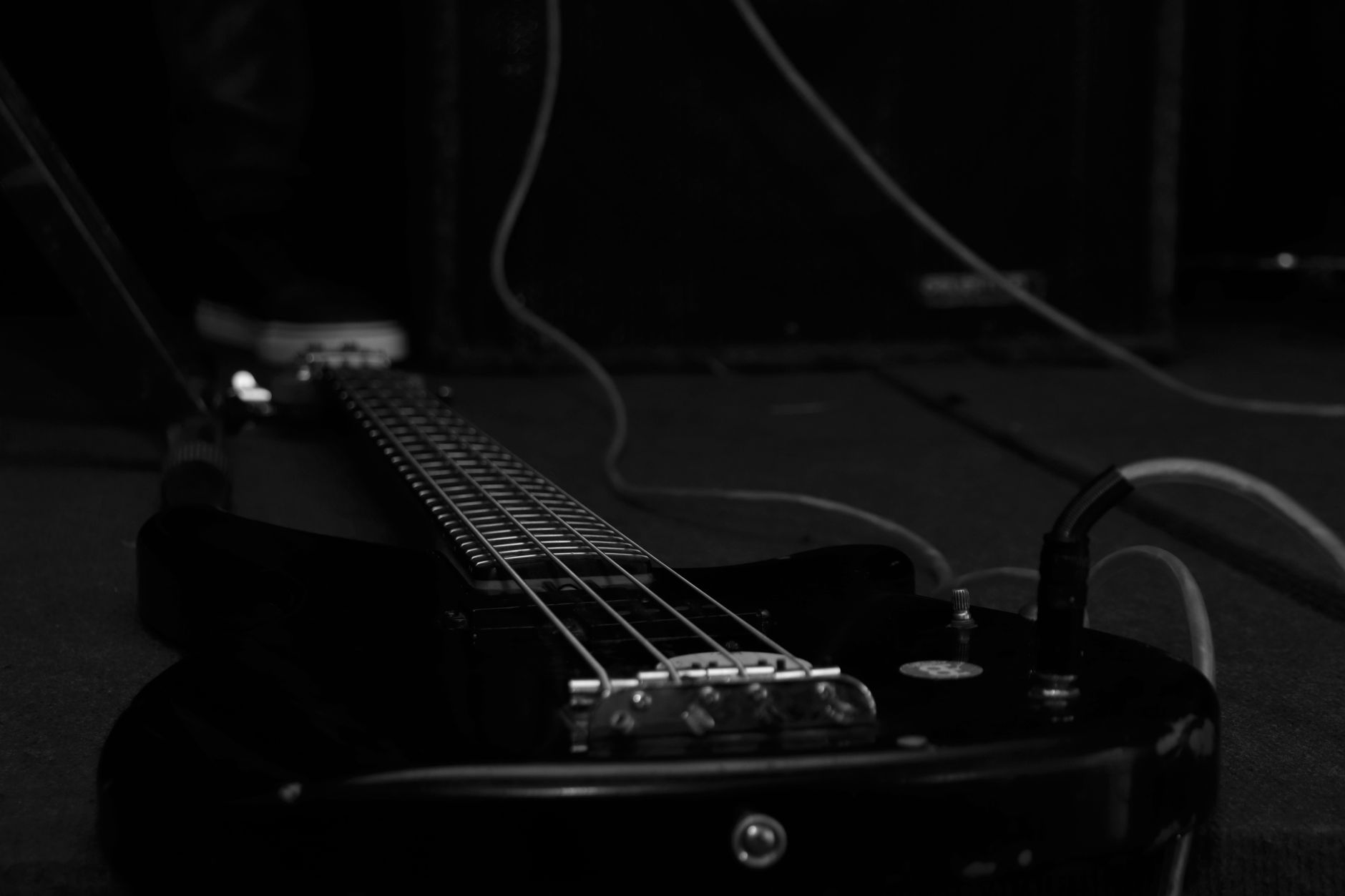 Close-up of a black electric guitar in a dark studio. Perfect for music-related themes.